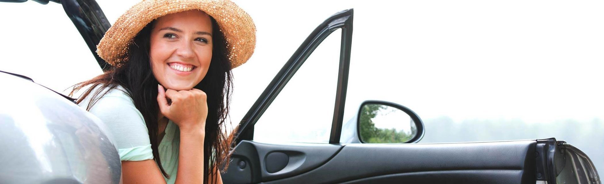 woman sitting in car happy