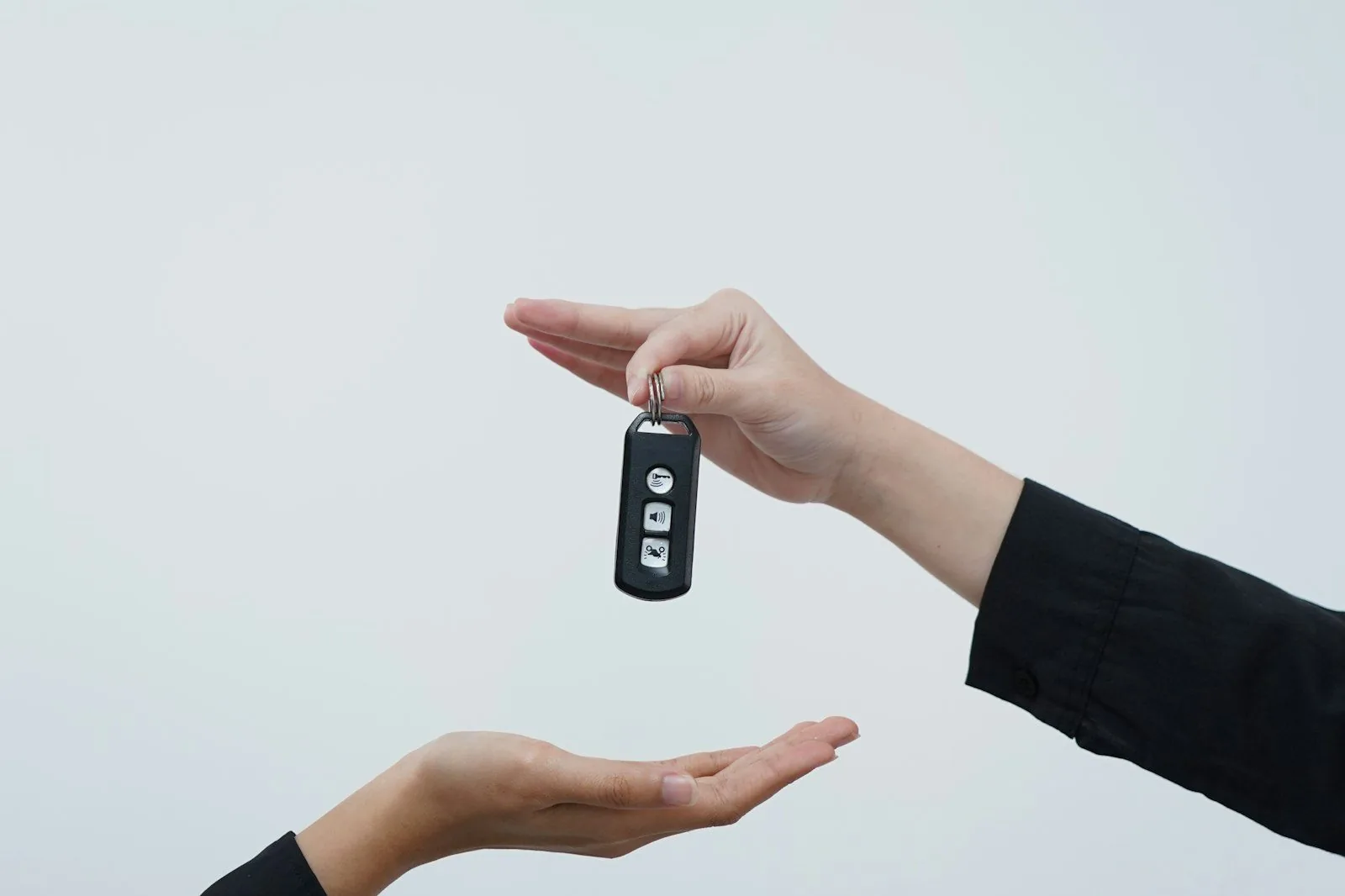 Salesperson handing car keys to a buyer approved with bad credit at a Houston dealership