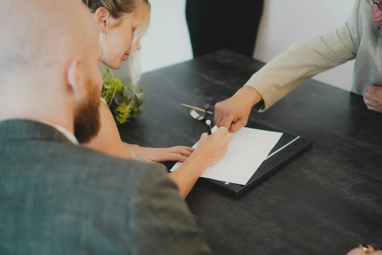 Buyer signing auto loan paperwork for an in-house financed car in Texas
